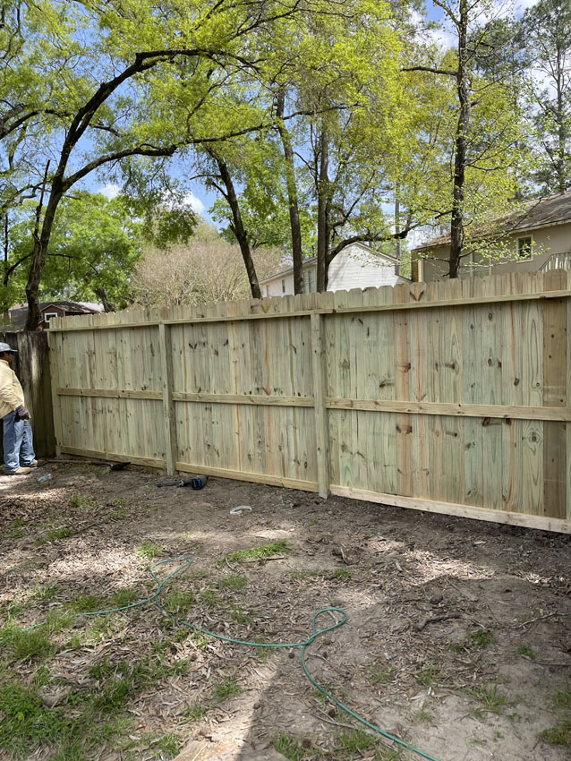New fence line installed on a cleared residential lot
