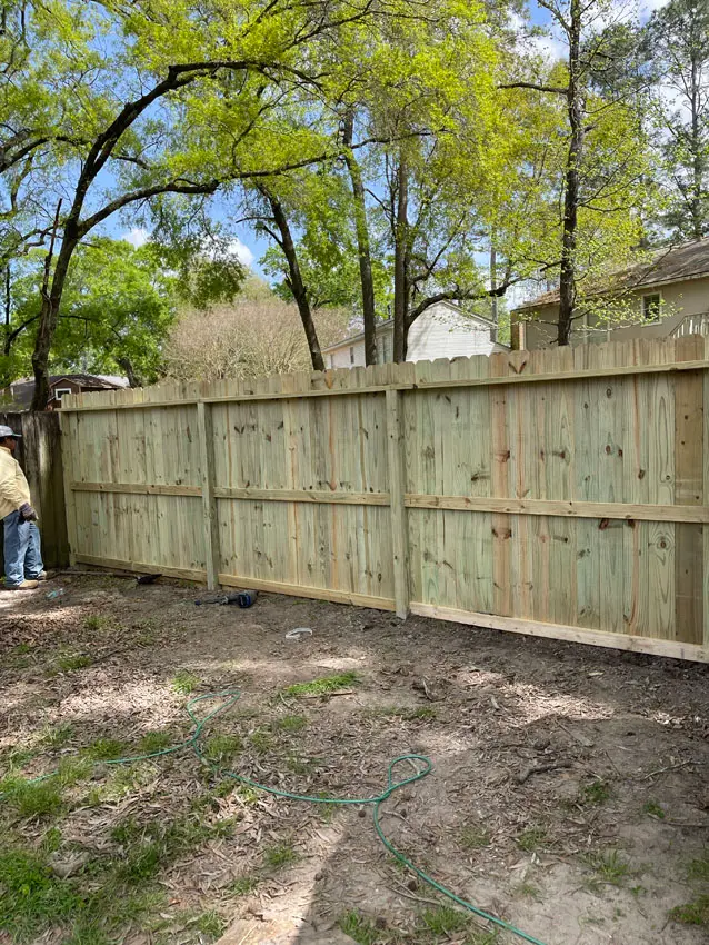 New fence line installed on a cleared residential lot